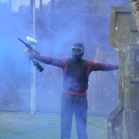 player standing near paintball smoke grenade
